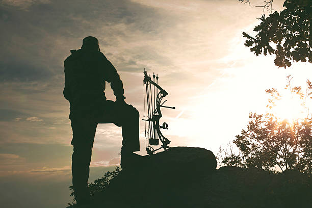 Profile of bowman with bow and arrow.