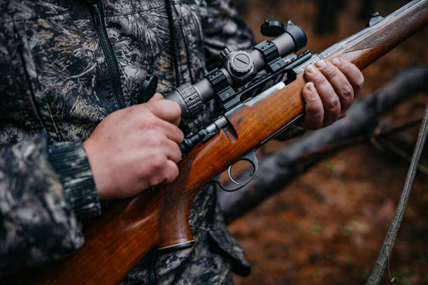 The hunter prepares the rifle